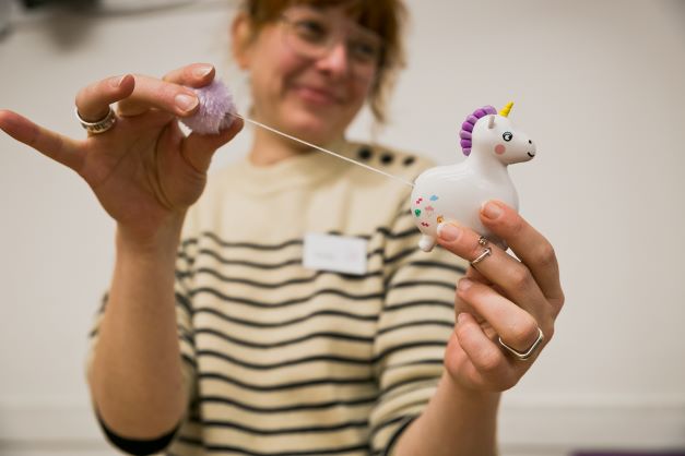 Pull string toy being repaired