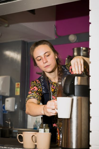 Volunteer making a hot drink